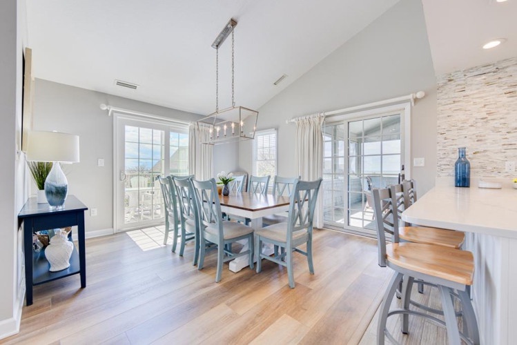 Step into this bright coastal dining space where your morning coffee meets mountain and ocean views. Natural light pours through French doors onto a spacious table that seats your whole group comfortably for meals and laughter.
