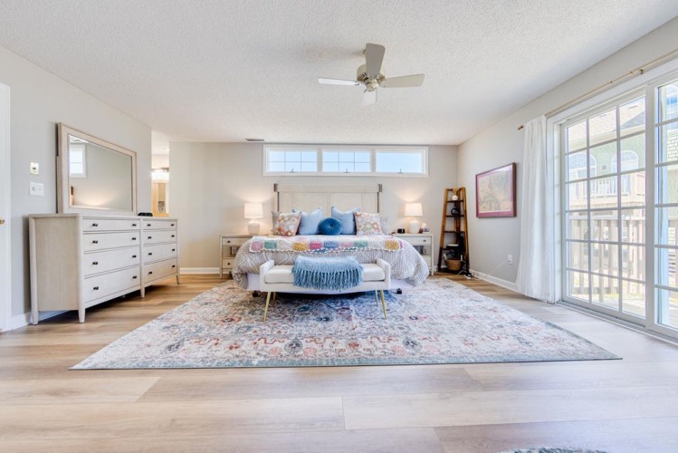 Unwind in your spacious primary suite, where soft natural light, plush bedding, and elegant décor create a serene retreat perfect for rest and relaxation.