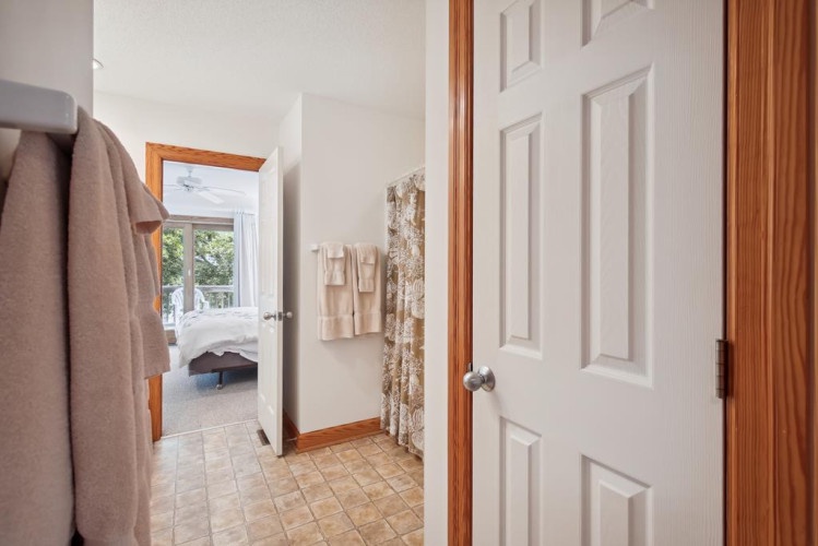 Your private retreat awaits, with plush towels and a peaceful bedroom view that invites you to unwind after a day of adventure.