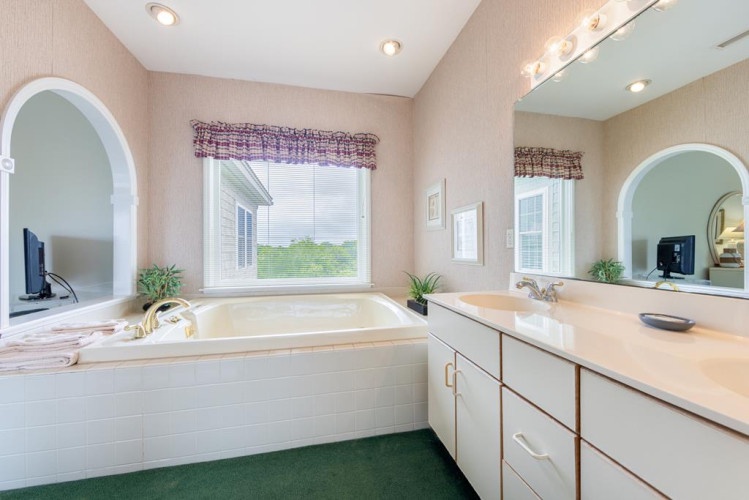 Unwind in your spacious en-suite with a deep soaking tub framed by natural light, modern fixtures, and thoughtful touches that make every moment feel indulgent.