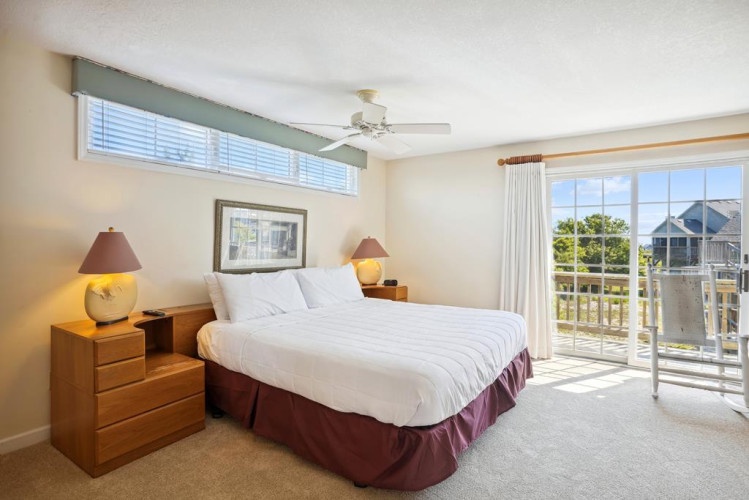 Wake up to natural light streaming through your balcony doors, inviting you to step outside and breathe in the fresh coastal air. Your serene retreat awaits with a plush bed and tranquil views.