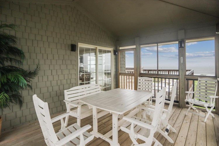 Your private deck invites you to gather around the white table, soak in the coastal breeze, and watch the sky meet the sea from your beachside escape.