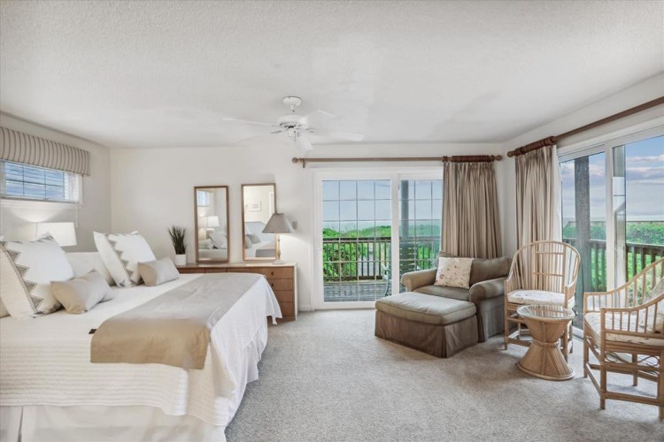 Wake up to serene views in your spacious bedroom where comfort meets coastal charm. Relax in the cozy sitting area or step onto your private balcony to breathe in the fresh air.