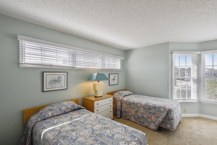 Two comfy twin beds await in this peaceful room, where soft natural light and calming colors help you unwind after a day of adventure.