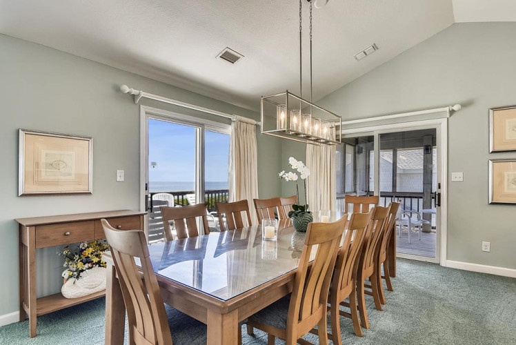 Gather around this spacious dining table with ocean views through your patio doors. Light streams in, making every meal feel like a celebration. Your private balcony beckons just beyond.