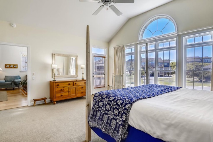 Your spacious master suite invites you to wake up to natural light pouring through tall windows overlooking the neighborhood. Enjoy high ceilings, a ceiling fan for comfort, and direct access to your private balcony.