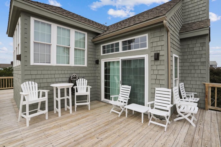 Your private deck awaits with Adirondack chairs and lounge seating—perfect for morning coffee or unwinding under coastal skies after a day of exploration.