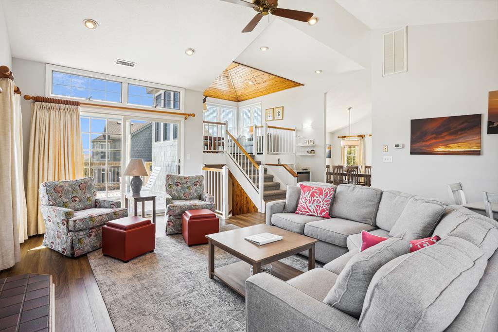 Sink into plush sofas and unwind in your bright, airy living space with vaulted ceilings, coastal charm, and room to gather with loved ones over laughter and stories.