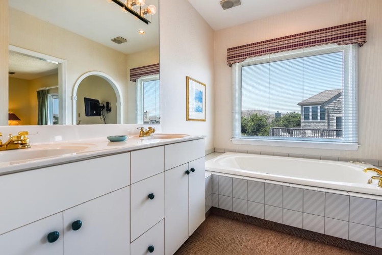 Relax in your private spa-like retreat with a soaking tub and refreshing coastal views—perfect for unwinding after a day exploring the area.