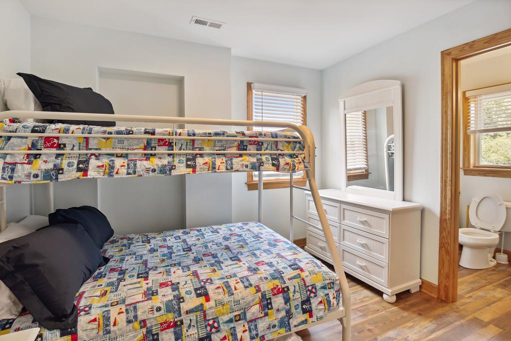 Your kids will love the playful bunk bed setup, complete with colorful bedding and a private attached bathroom—perfect for family adventures.
