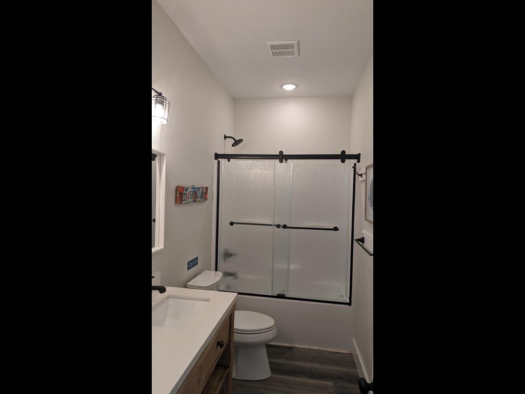 Step into your spotless private bathroom with a modern walk-in shower, fresh towels, and a sleek, contemporary design that makes every morning feel refreshing.