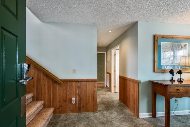 Step into your private hallway with warm wood accents and soft lighting guiding you to each room. A cozy retreat awaits where rustic charm meets modern comfort.