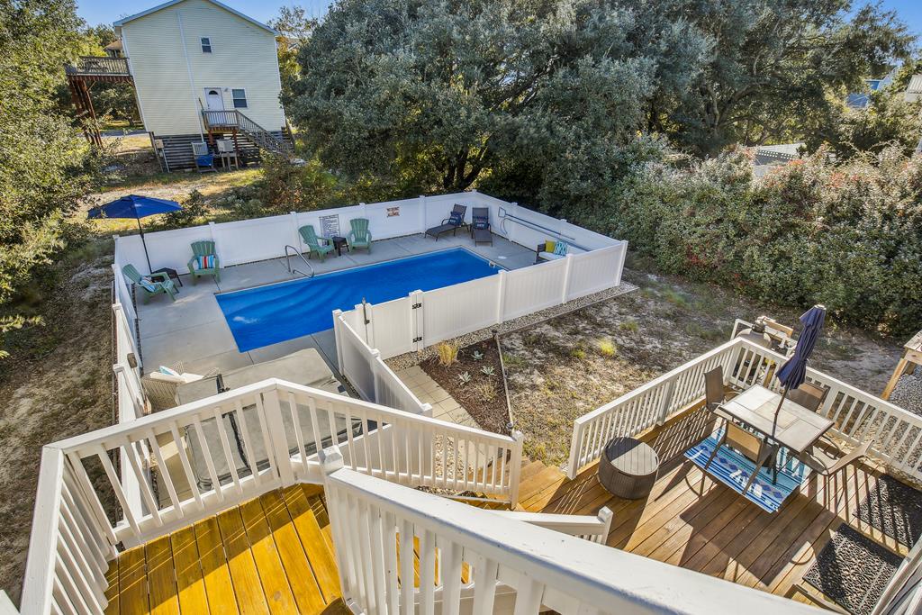 The property features a private swimming pool surrounded by a spacious deck, complete with multiple outdoor decks and seating areas for relaxing under the sun.