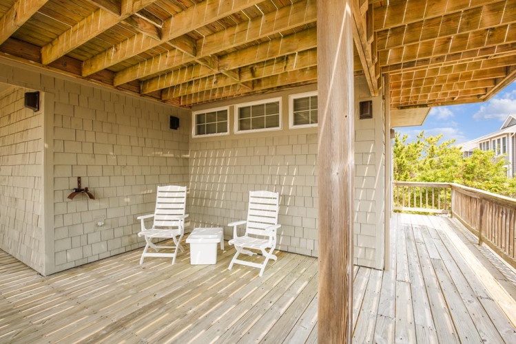 Your private covered deck with rocking chairs awaits—perfect for sipping morning coffee or unwinding as the day winds down in your peaceful retreat.