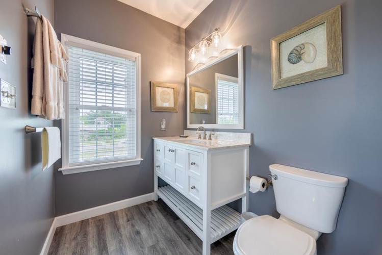 Your private bathroom features calming coastal tones, fresh towels, and bright natural light—a serene space to refresh during your stay.