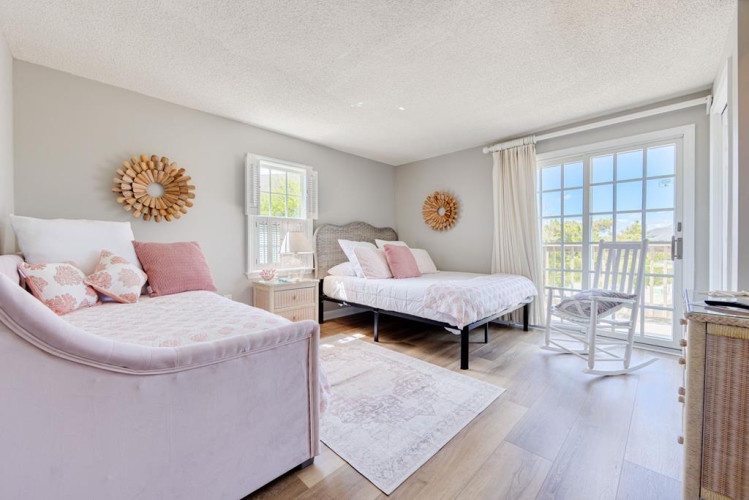 Soft blush tones and natural light create a peaceful retreat where you can unwind with serene views just beyond your private balcony.