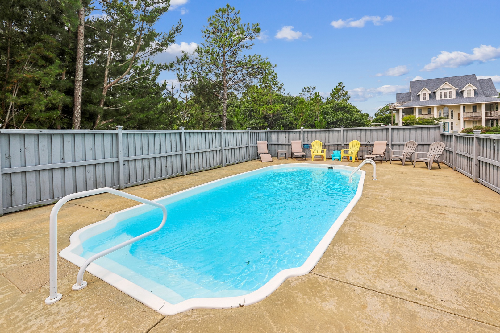 Your private pool awaits, surrounded by colorful loungers and a spacious deck for soaking up the sun. Dive in, relax poolside, and enjoy lazy afternoons in this inviting outdoor retreat.