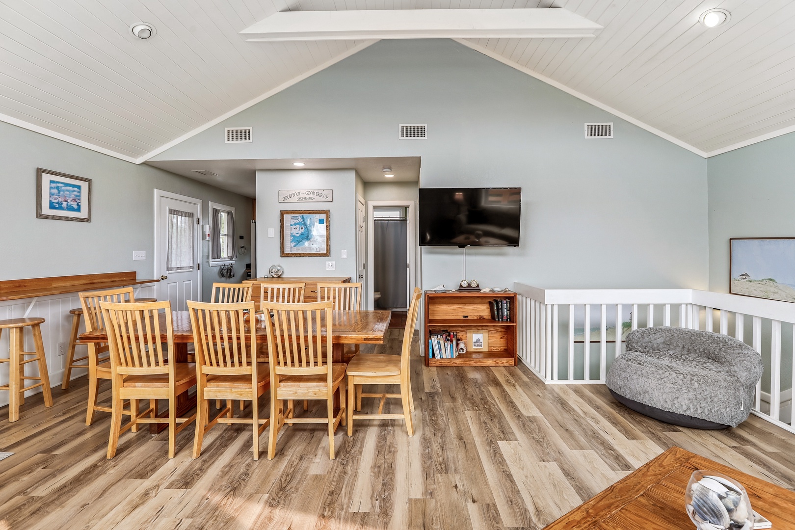 Gather around the large wooden dining table for memorable meals in this bright, vaulted space. Your coastal retreat awaits, with room for everyone to relax and reconnect.