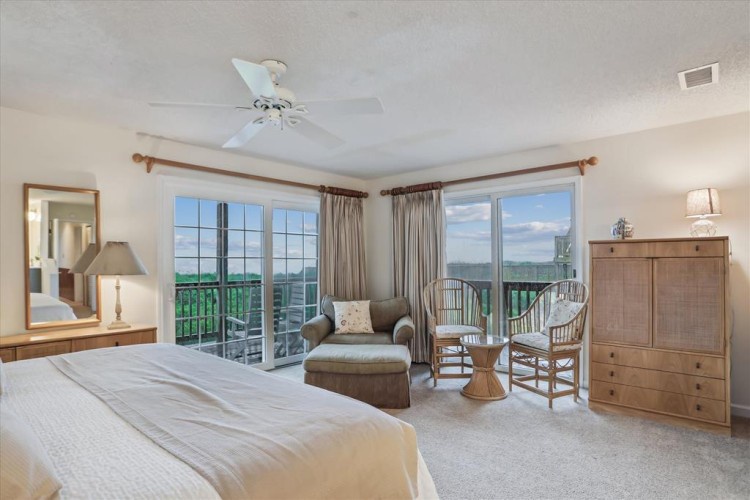 Wake to lake views through expansive windows framing your private balcony, where morning coffee feels like a retreat.