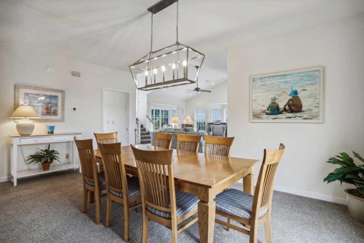 Gather around this welcoming dining table with seating for eight, perfect for your family meals and vacation memories. The open layout flows seamlessly into the living spaces, creating an inviting atmosphere for connection.