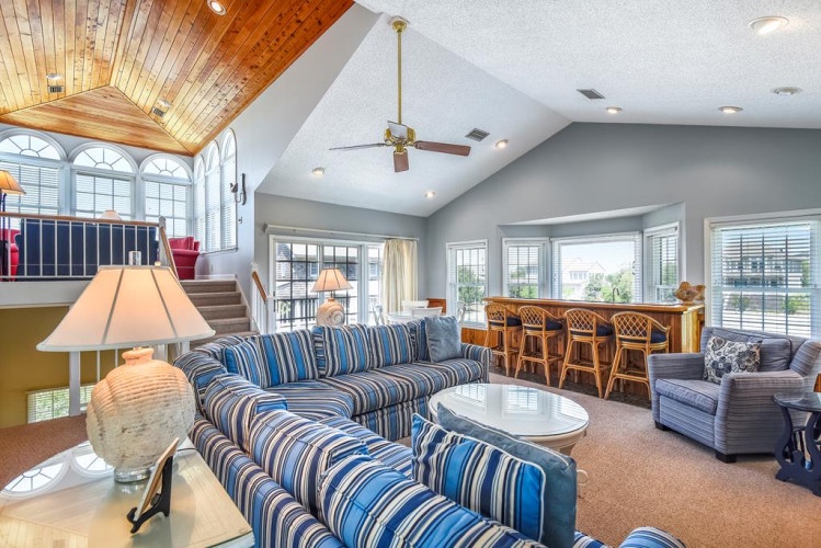 Unwind in your spacious open-concept haven with soaring vaulted ceilings and stunning natural light. Relax on plush seating, gather at the inviting bar, or step onto the balcony to soak in serene views.