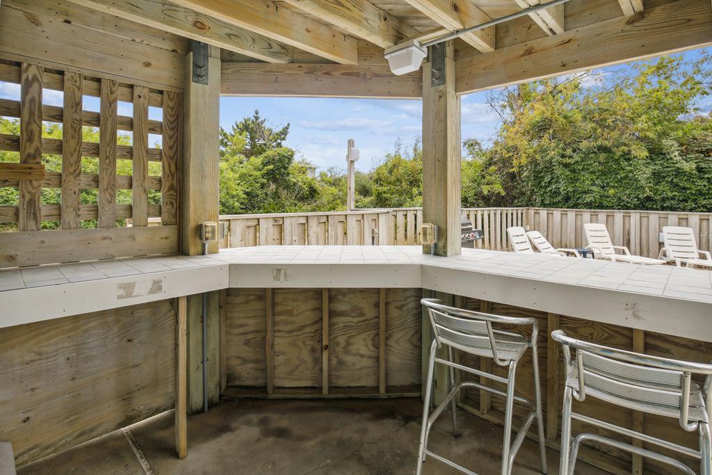 Sip your morning coffee at your private outdoor bar while soaking in peaceful garden views and fresh air on this covered deck.