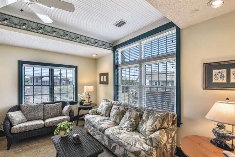 Unwind in your bright, airy living space where large windows and cozy seating invite you to relax and feel right at home after a long day.