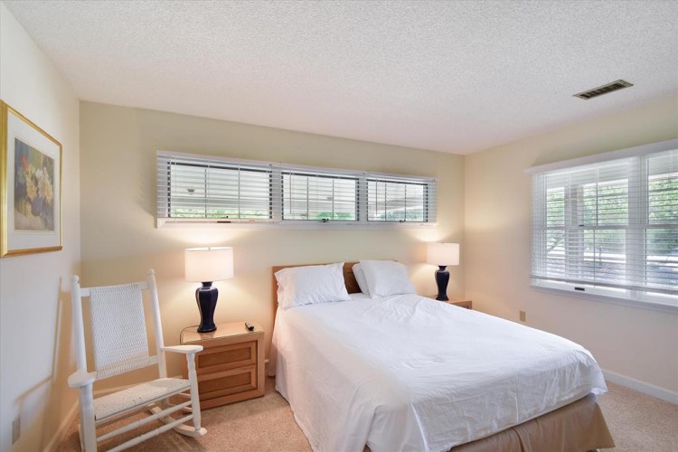 Wake up to soft natural light streaming through the windows, illuminating crisp white linens and warm wood accents that make your mornings feel refreshingly peaceful.