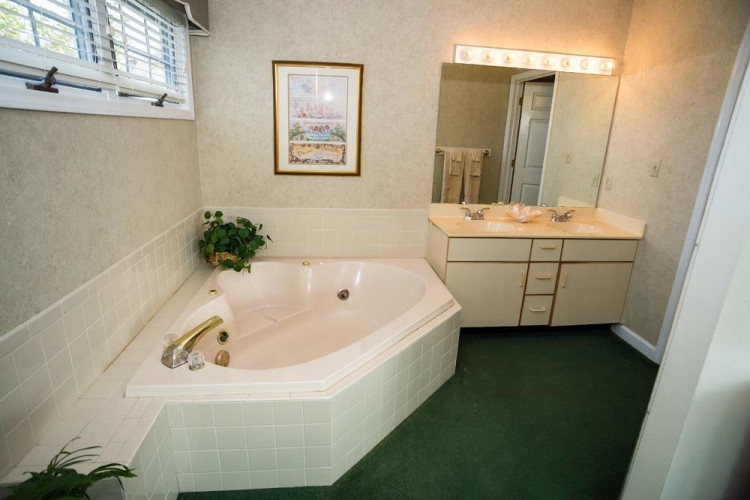 Your private bathroom features a luxurious corner soaking tub, perfect for unwinding after a day of exploring, plus a spacious vanity with plenty of storage for all your essentials.