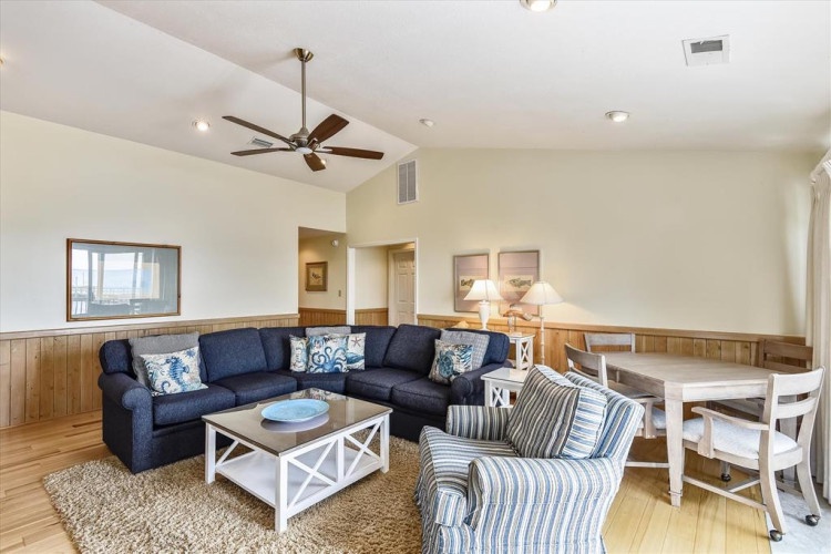 Unwind in your spacious living area with comfortable seating, natural light, and a ceiling fan to keep you cool during your stay.