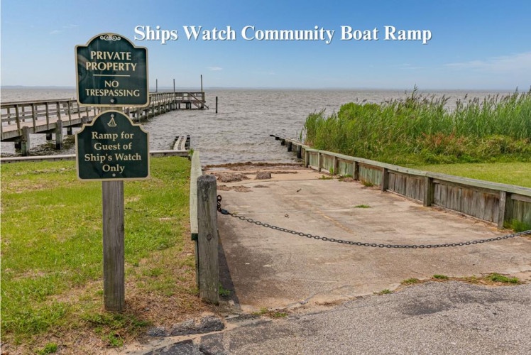 Ships Watch Community Boat Ramp provides exclusive waterfront access for guests, with a private dock extending into the bay surrounded by natural marshlands and open water views.