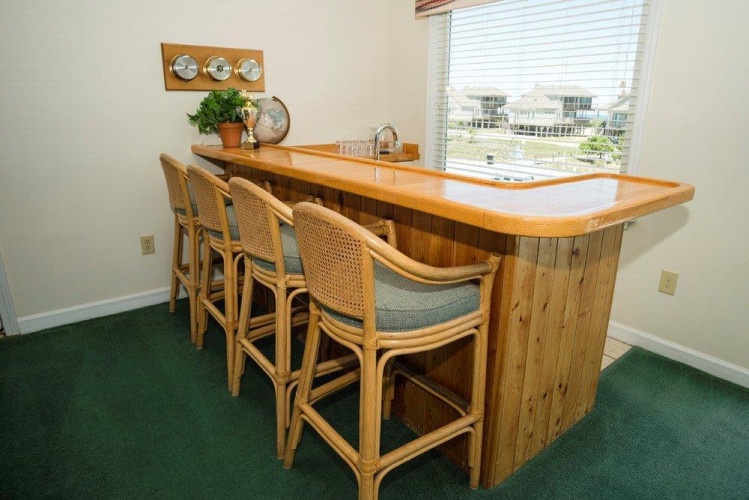 Gather around this welcoming bar, perfect for sharing stories and drinks with your group. The warm wood finish creates a cozy spot for lively conversation.