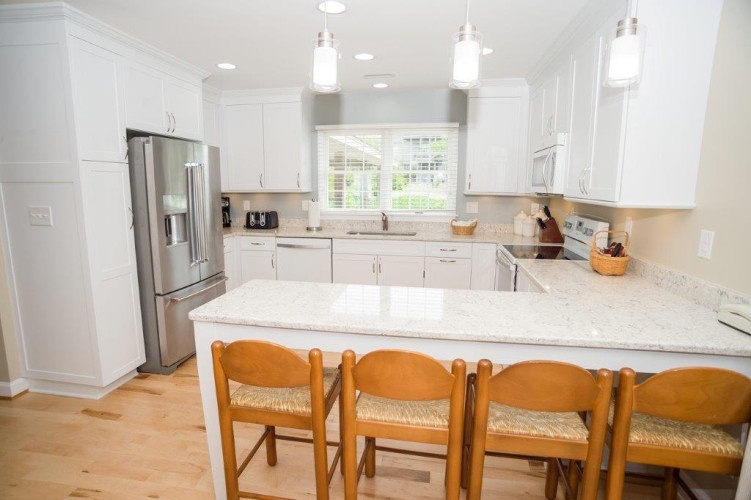 Your bright, fully equipped kitchen awaits—gleaming countertops, modern appliances, and a spacious island where you can gather for morning coffee or prepare a leisurely meal together.