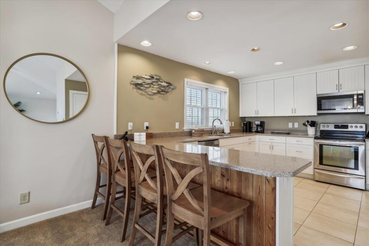 Gather at this spacious granite island with your group, brew fresh coffee, and start your mornings together in this bright, fully-equipped kitchen with modern appliances.