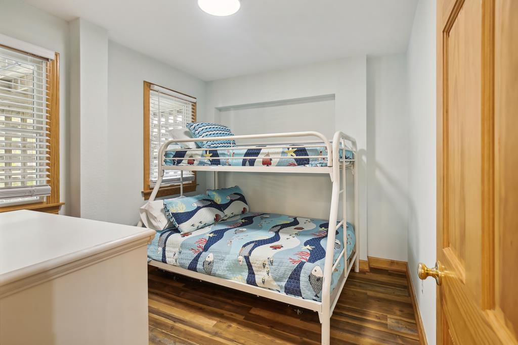 Your kids will love this cozy bunk room with cheerful bedding, warm natural light from the window, and plenty of space to settle in for a restful night's sleep.