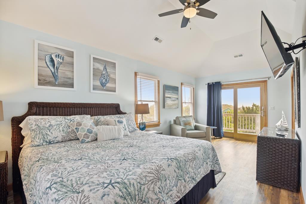 Wake up to bright views and coastal-inspired comfort in this spacious bedroom. Your private retreat features a plush bed, cozy seating nook, and direct balcony access—perfect for your morning coffee or sunset unwind.