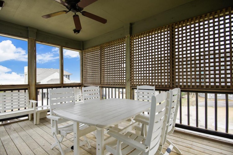 Dine al fresco on your private screened porch with lattice privacy walls, ceiling fan, and coastal breezes. Perfect for morning coffee or evening gatherings while taking in the peaceful surroundings.