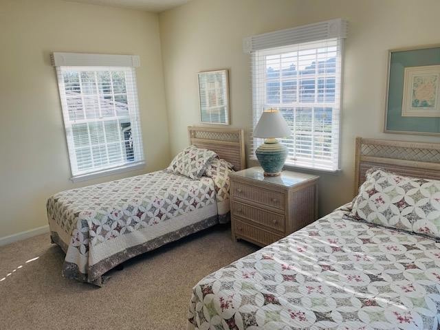 Settle into your cozy twin bedroom retreat, where soft natural light and charming quilted bedding create a peaceful space for restful nights and relaxing mornings.