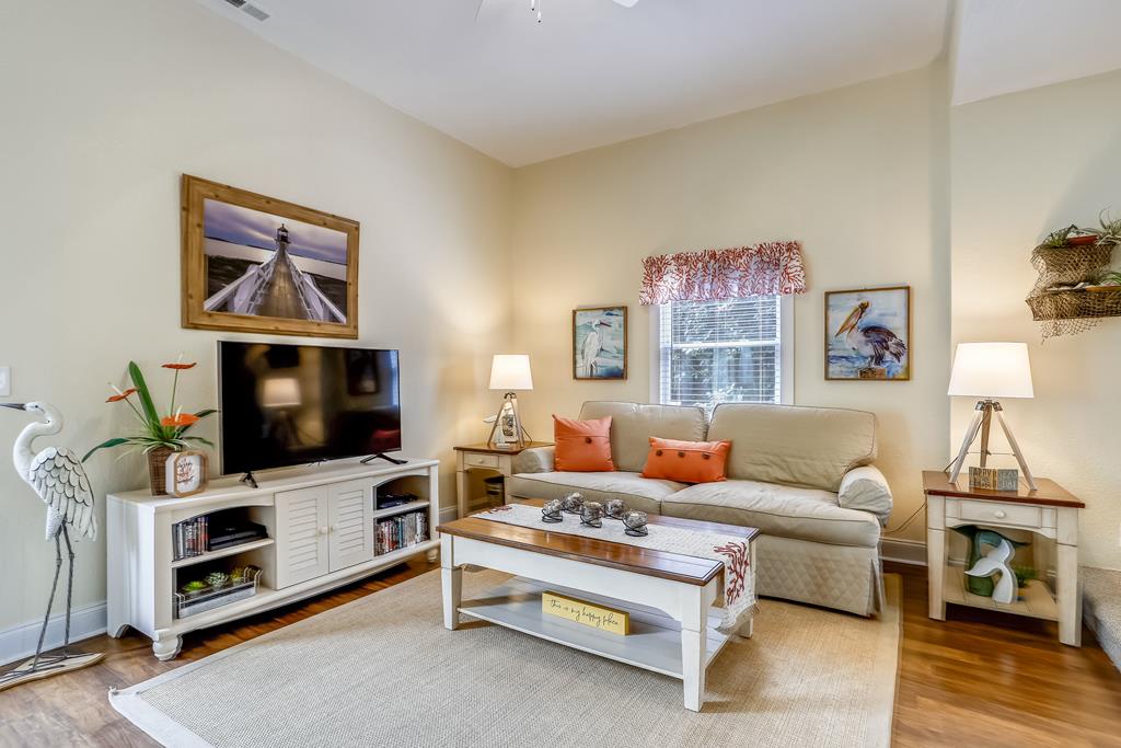 Your coastal-inspired living room awaits with a plush sofa, charming nautical touches, and warm lighting. Settle in with a cup of tea and let the calming hues and beachside artwork help you unwind.