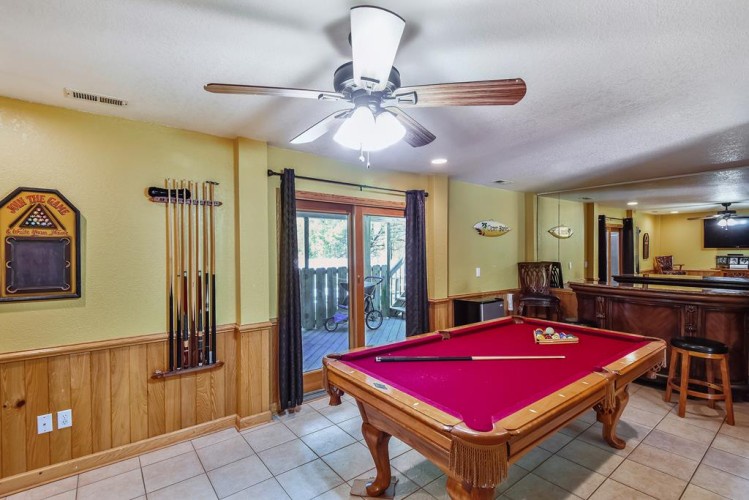 Picture your game night here—shoot pool under soft lighting, step out to the balcony for fresh air, or relax at the bar with friends in this inviting recreation space.