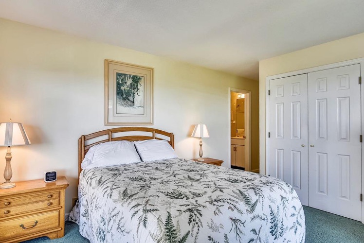 Step into your serene bedroom retreat featuring a plush queen bed, soft bedside lighting, and a convenient ensuite bathroom just steps away from where you'll wake up refreshed.