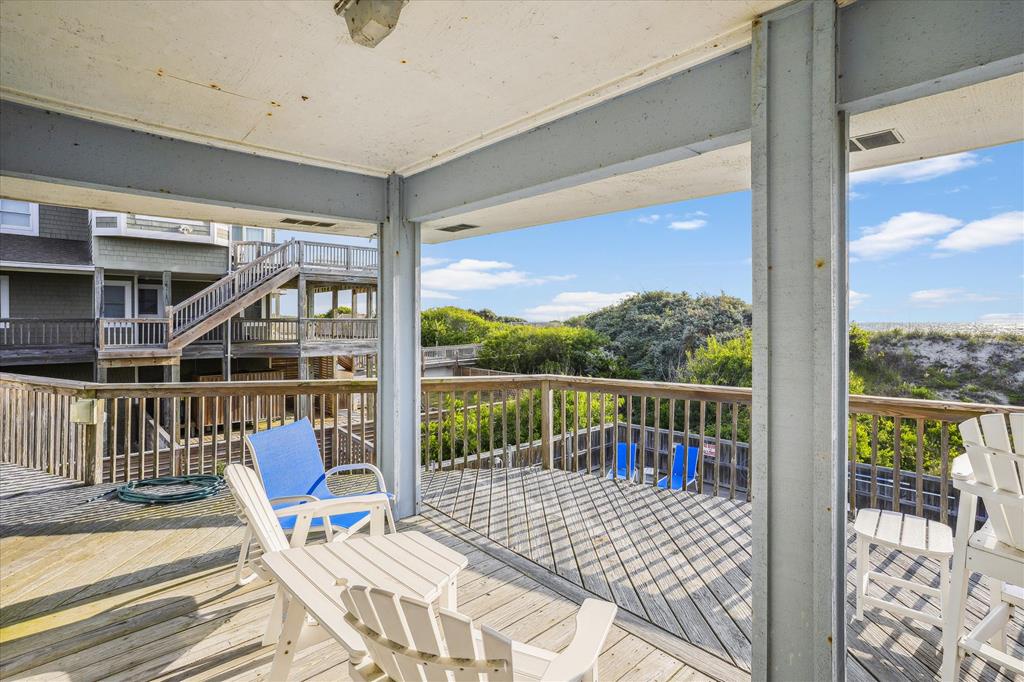 Step onto your private deck where coastal breezes meet serene natural views. Unwind in Adirondack chairs and soak in the peaceful surroundings—your perfect retreat awaits.