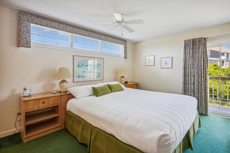 Sink into this inviting bed with crisp linens and plush pillows, where natural light fills your peaceful retreat. Wake refreshed to garden views from your private balcony.