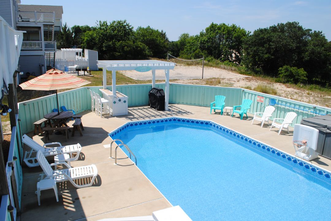 Dive into your private oasis—a sparkling pool surrounded by comfortable loungers and shaded seating. Feel the sun on your skin as you relax by the water's edge.