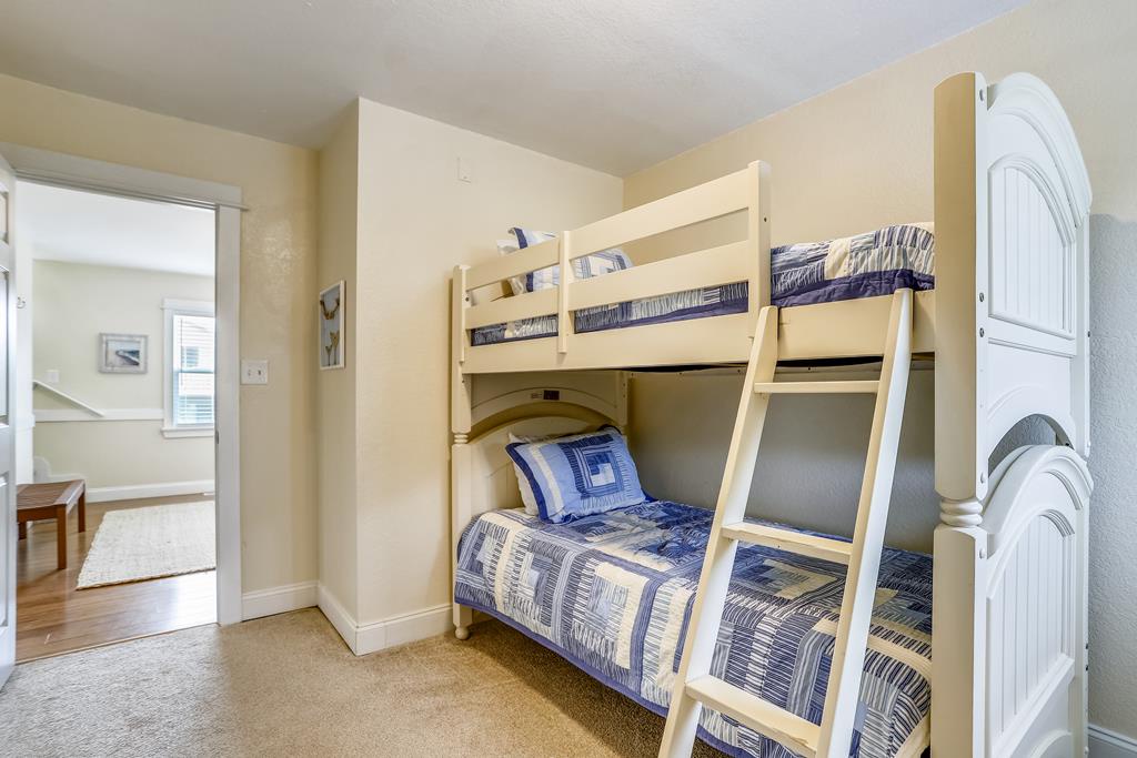 Perfect for the kids, this cozy bedroom features a sturdy bunk bed with soft blue quilts, offering your little ones their own special sleeping space.
