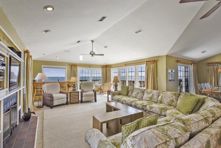 Settle into a sun-drenched living space where coastal breezes and endless ocean views become part of your daily escape.