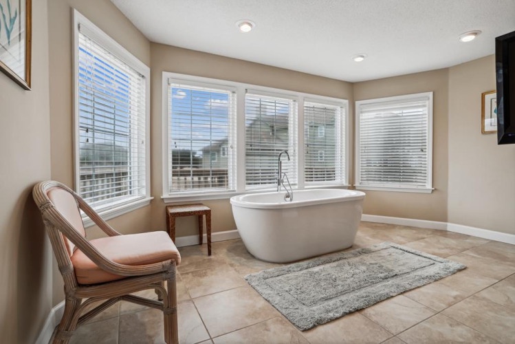 Picture yourself unwinding in this elegant soaking tub, framed by soft natural light and peaceful views. Your private retreat awaits with plush seating and serene touches.