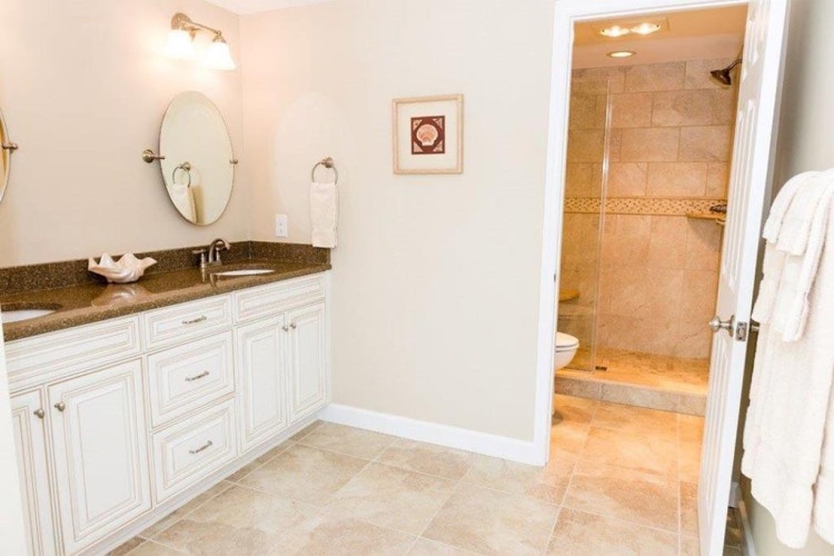 Your private bathroom awaits with a spacious vanity, soft lighting, and a walk-in shower with plenty of room to refresh after a day of adventure.