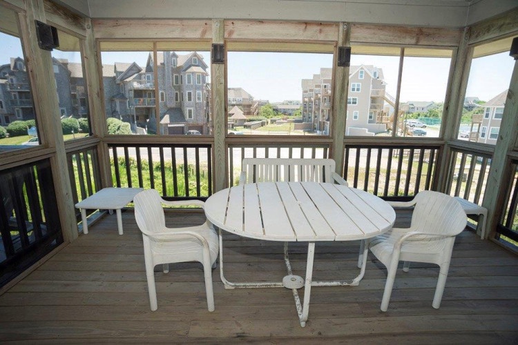 Your screened porch offers a breezy retreat with waterfront and neighborhood views. Settle into the outdoor seating and enjoy the fresh air and coastal scenery.