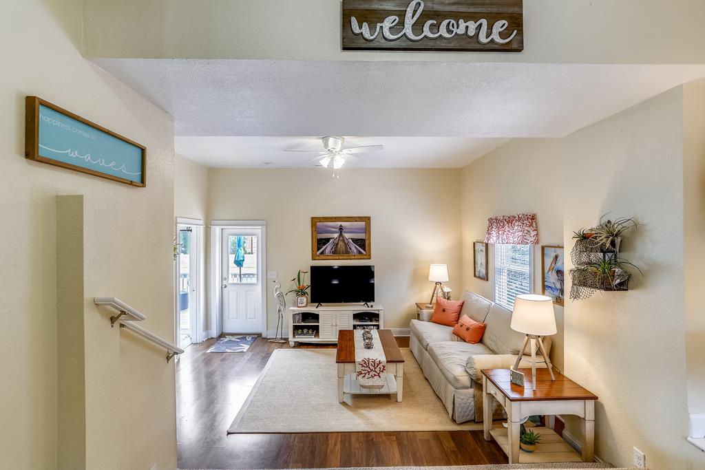 Relax in your bright living room with coastal décor, comfy seating, and entertainment ready. The welcoming entryway and open layout help you feel right at home the moment you arrive.